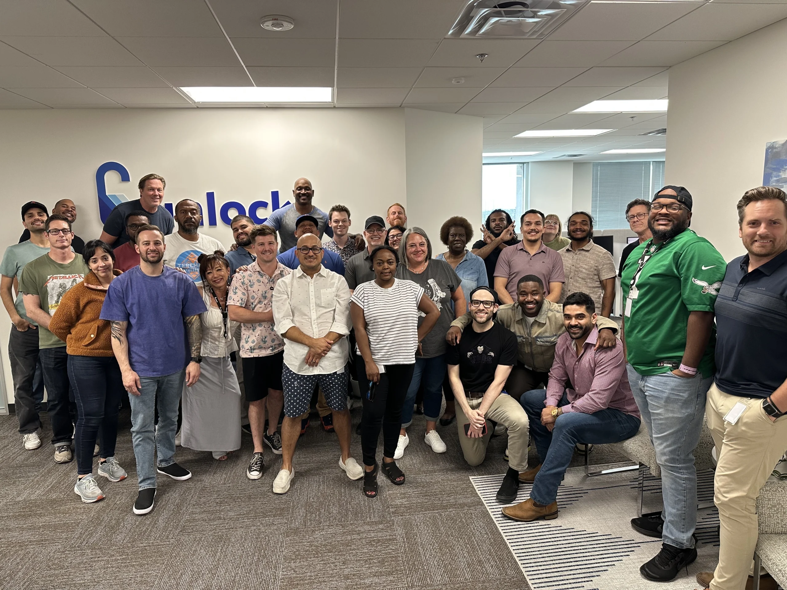 Photograph showing members of the Unlock team in their offices, smiling and looking at the camera as a group.
