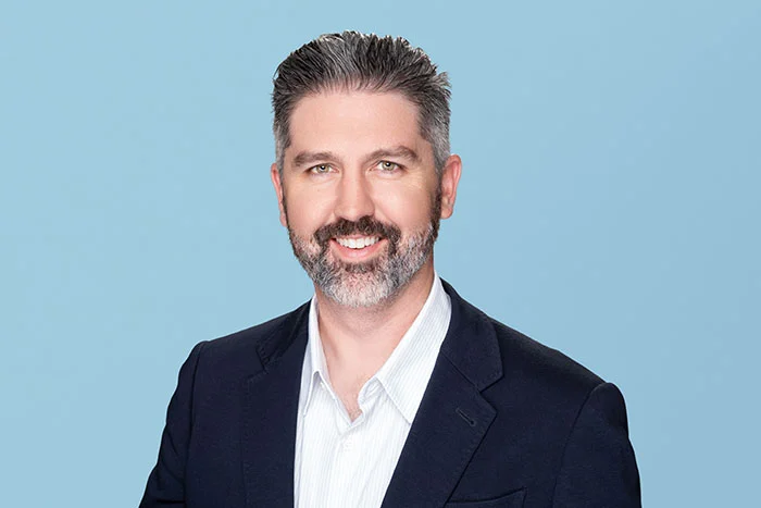 Photograph of Unlock's Chief Financial Officer & Chief Business Officer Kevin Nerney smiling and looking at the camera.