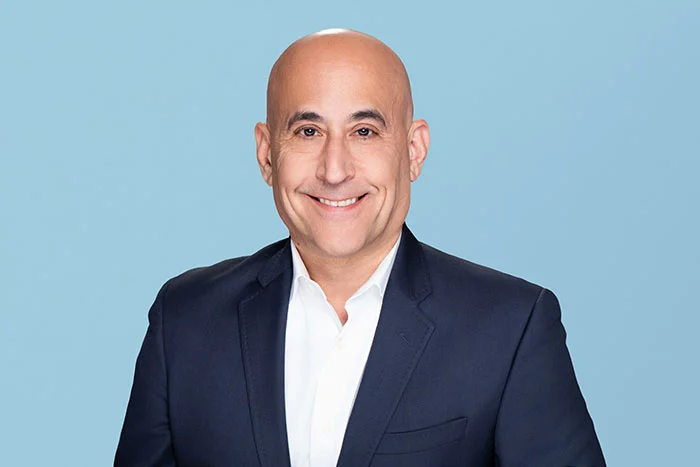 Photograph of Unlock's General Counsel Lee Kaplan smiling and looking at the camera.