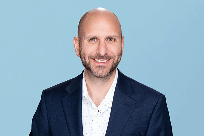 Photograph of Unlock's Chief Marketing Officer Michael Micheletti smiling and looking at the camera.